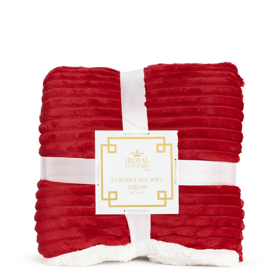 Red textured throw blanket with a white label on a white background