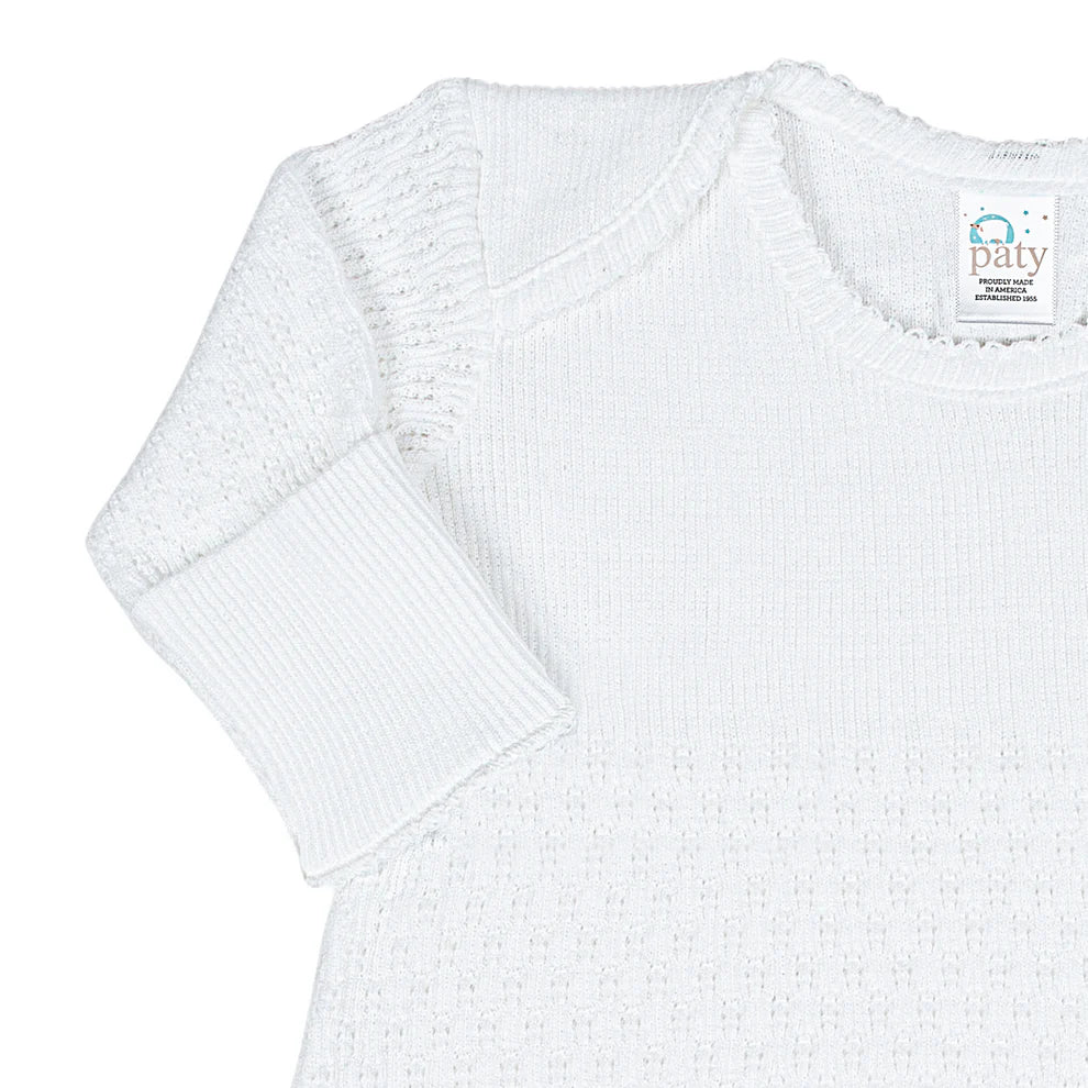 White textured gown with a Paty label on a white background