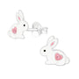 White rabbit-shaped earrings with pink hearts on a white background