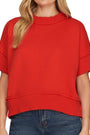 Red sweater worn by a person on a white background