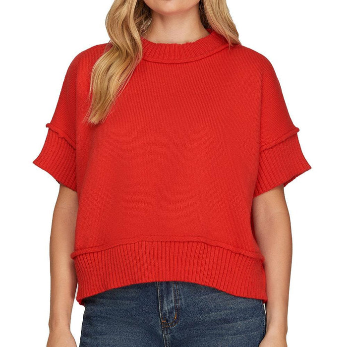 Red sweater worn by a person on a white background
