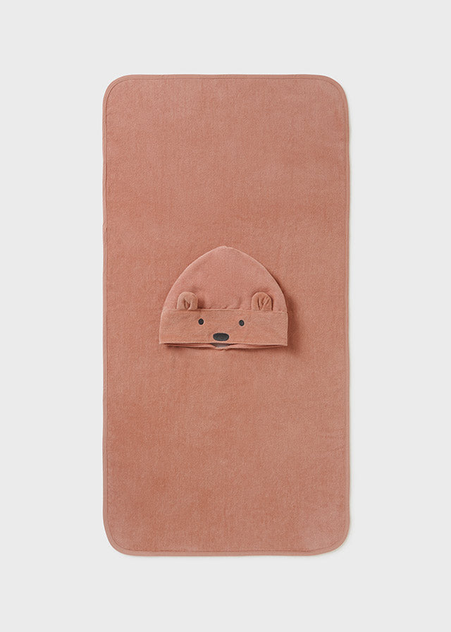 Pink baby blanket with a bear face on a light gray background