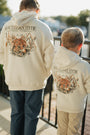Two people wearing cream-colored hoodies with 'Southern Hyde Clothing Company' logo and tiger design.
