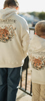 Two people wearing cream-colored hoodies with 'Southern Hyde Clothing Company' logo and tiger design.