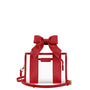 A red structured handbag with a large bow on top, clear front panels, a small front pouch, and a matching red shoulder strap on a plain white background.