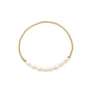 Gold bracelet with pearls on a white background