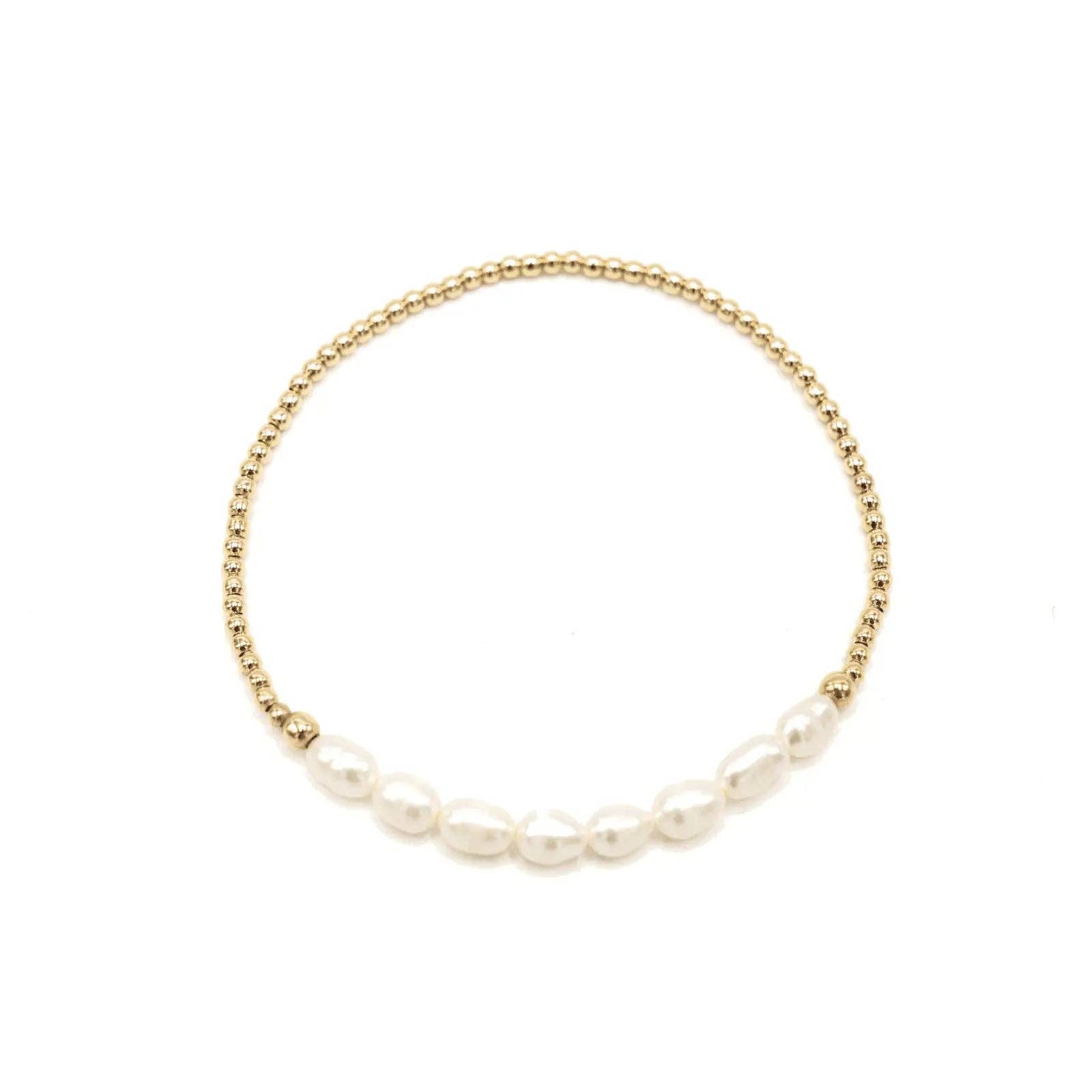 Gold bracelet with pearls on a white background