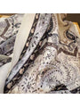 Muted grey vintage paisley triangle bandana scarf close-up, cream background with dark accents