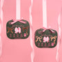 Two dark green fabric pouches tied with pink bows