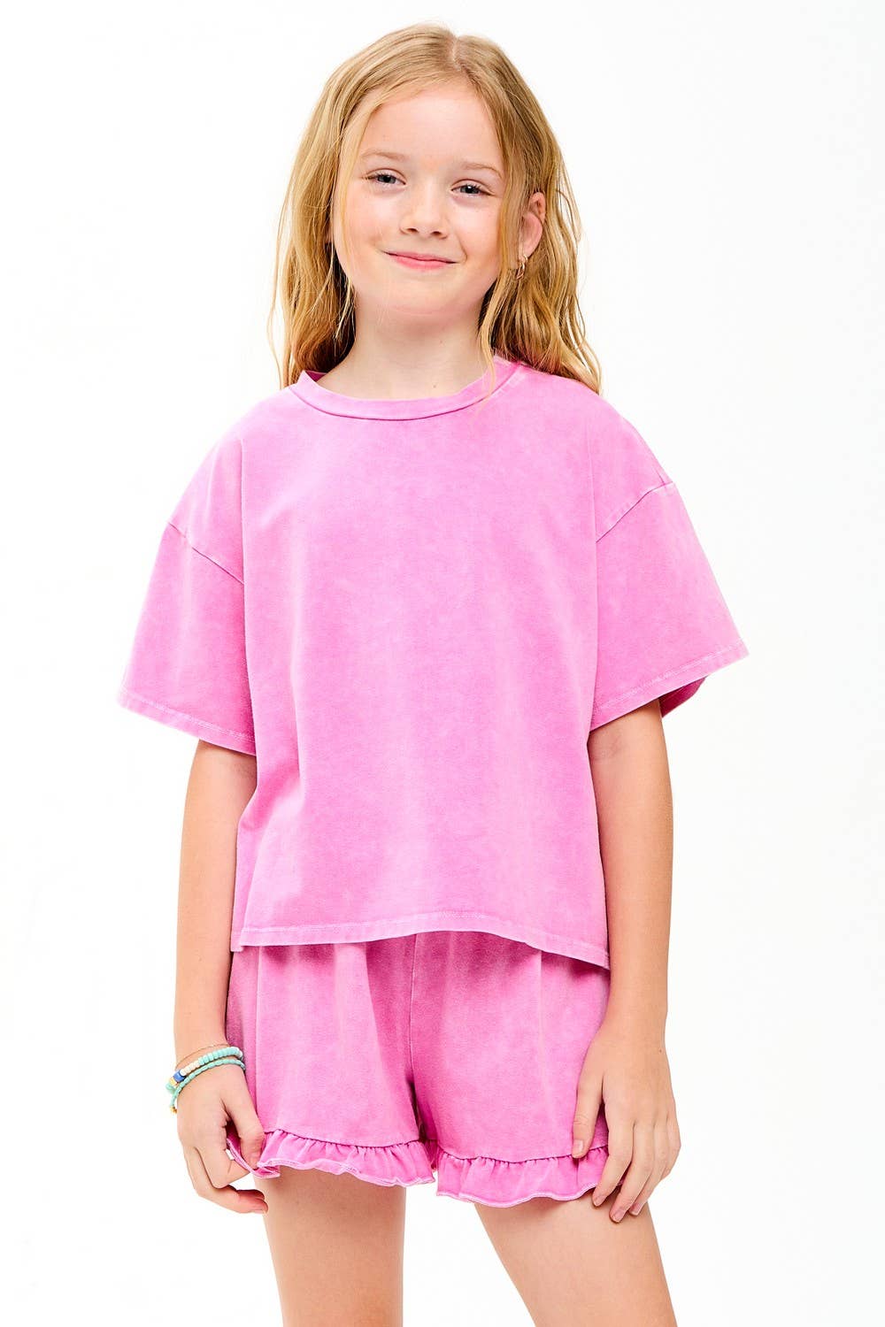 Young girl wearing a pink outfit on a white background