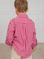 Child wearing a red and white checkered shirt with sleeves rolled up, standing against a neutral background.