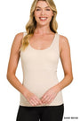 Woman wearing a sand beige tank top on a white background