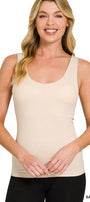 Woman wearing a sand beige tank top on a white background