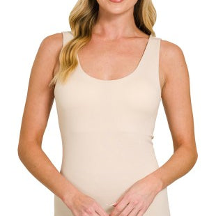 Woman wearing a sand beige tank top on a white background