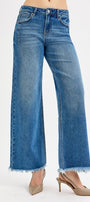 Blue jeans with a frayed hem on a white background