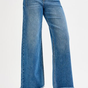 Blue jeans with a frayed hem on a white background