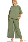 Woman wearing a light olive green outfit on a white background