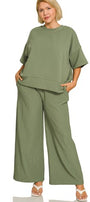Woman wearing a light olive green outfit on a white background