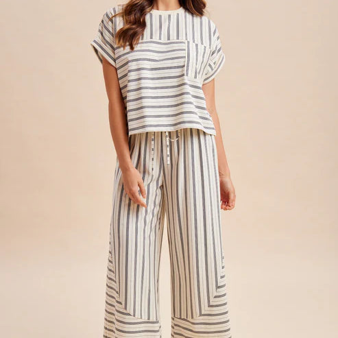 Woman wearing a striped outfit on a beige background