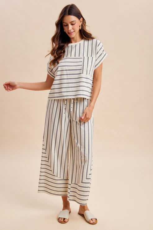 Woman wearing a striped outfit on a beige background
