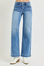 Blue jeans worn by a person on a light gray background