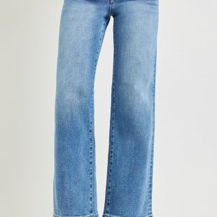 Blue jeans worn by a person on a light gray background