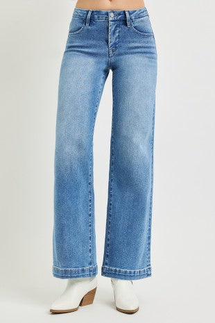 Blue jeans worn by a person on a light gray background