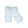 Pair of light blue textured baby socks on a white background