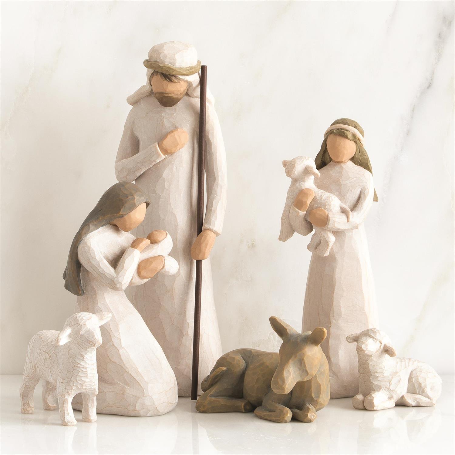 Nativity scene figurines with Mary, Joseph, baby Jesus, and animals on a white background