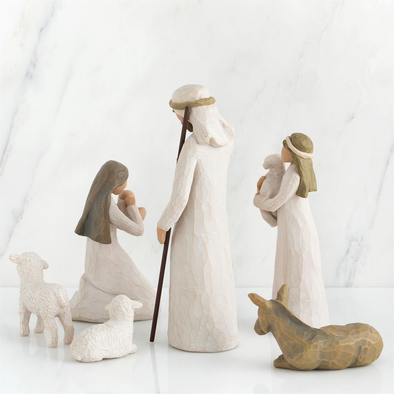 Nativity scene figurines with Mary, Joseph, and baby Jesus on a white background