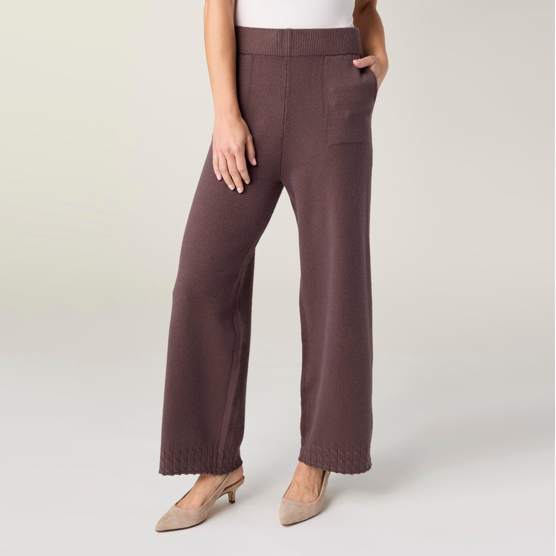 Brown wide-leg pants worn by a person on a white background