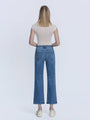 Person wearing blue jeans and a white top on a white background