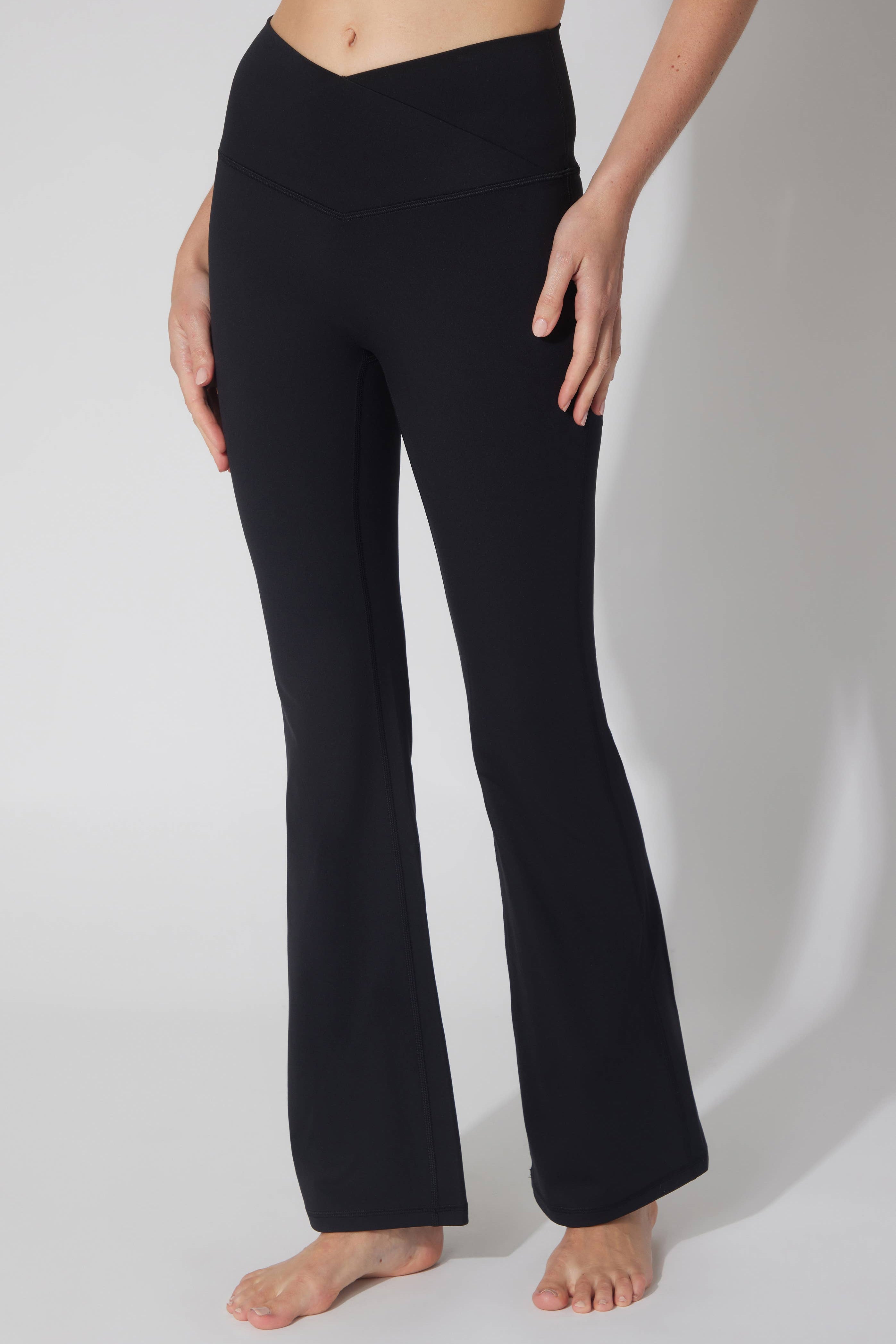 Black pants worn by a person on a white background