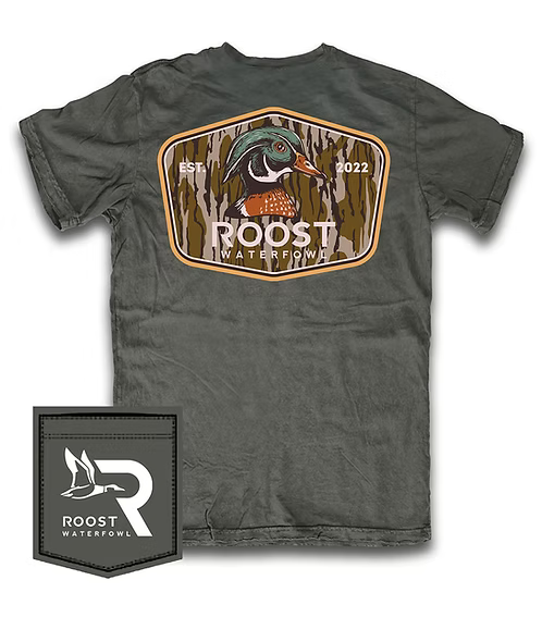 A dark gray crewneck t-shirt featuring a large back graphic of a mallard duck inside a camouflage-style shield with the text 'ROOST WATERFOWL' and 'EST. 2022'.