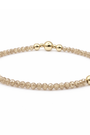 Bracelet with gold and beige beads on a white background