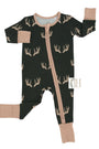 A baby long-sleeve footed sleeper in black with a tan deer antler pattern, featuring tan cuffs and a tan front zipper, shown on a white background.