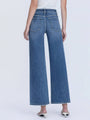 Person wearing blue wide-leg jeans on a white background