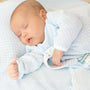 Newborn baby sleeping peacefully wrapped in a blue blanket