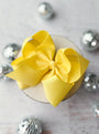 Yellow bow on a decorative box with silver embellishments