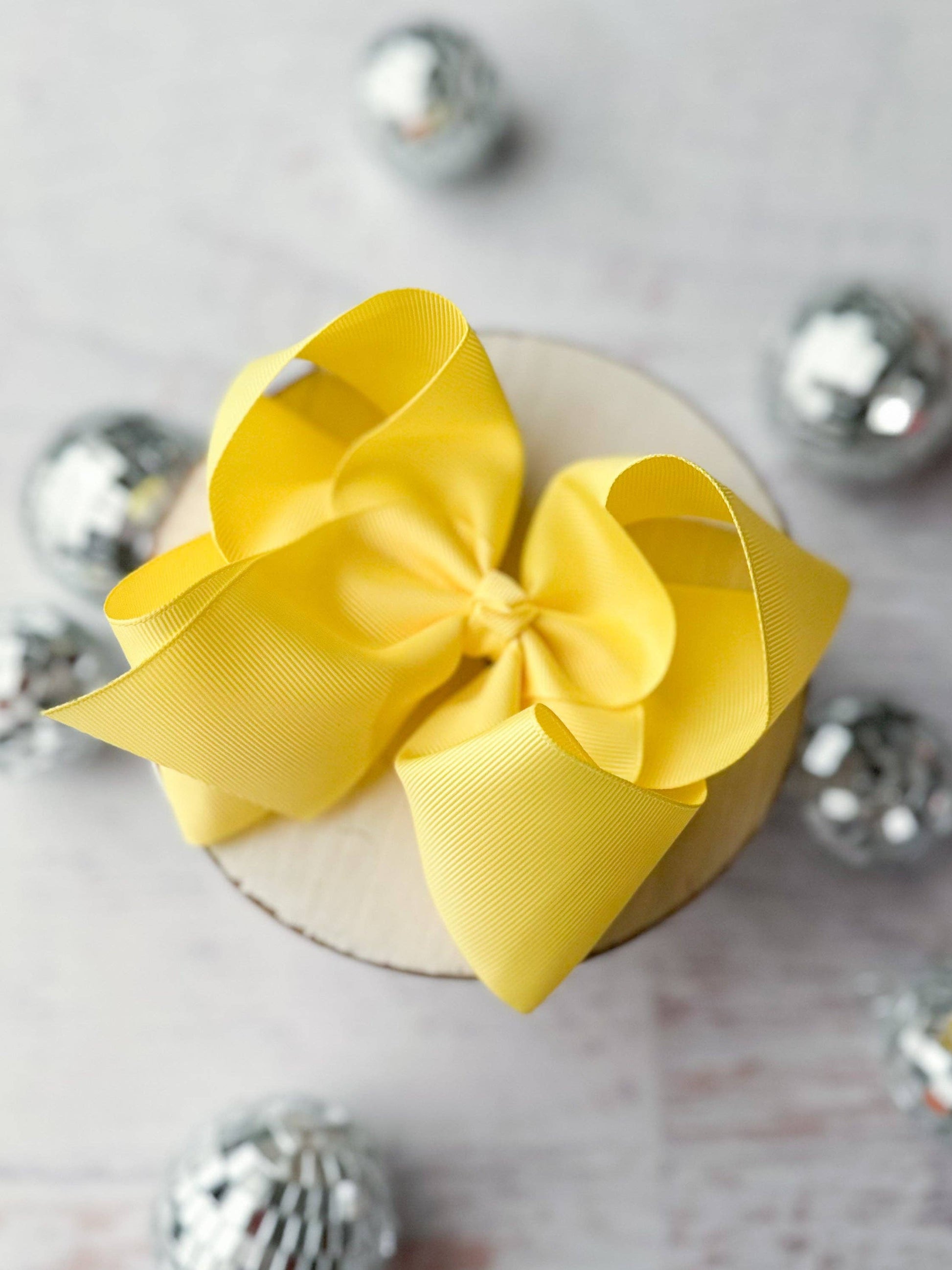 Yellow bow on a decorative box with silver embellishments
