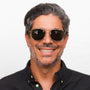 Man wearing sunglasses with a neutral background