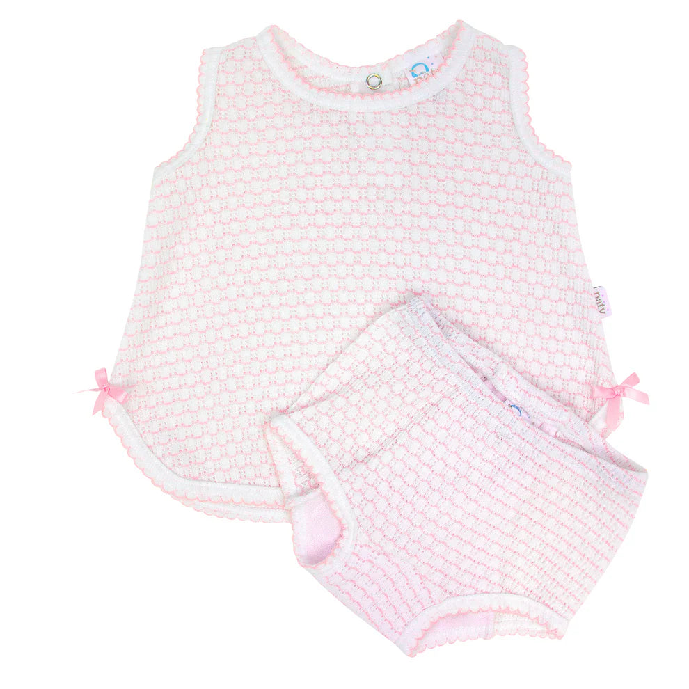 Baby romper with pink and white pattern on a white background