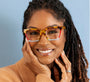 Woman wearing colorful glasses with a plain background