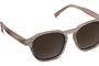 Sunglasses with brown frames and dark lenses on a white background