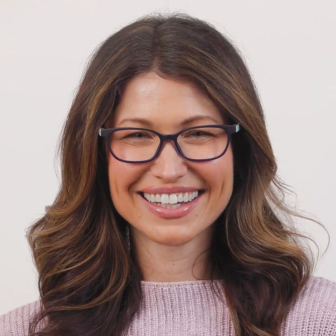 Woman wearing glasses with a plain background