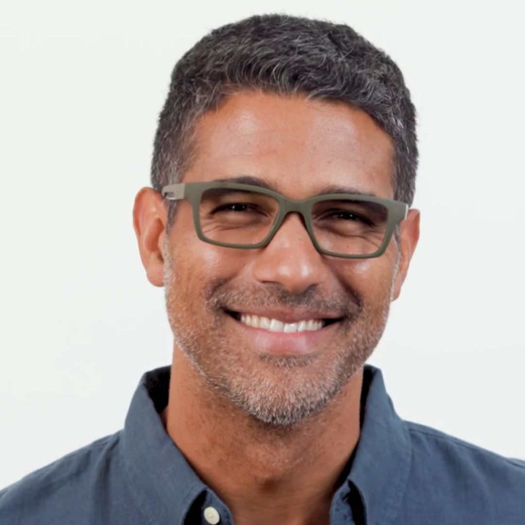 Man wearing glasses with a gray background