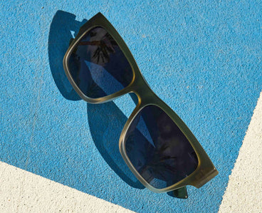 Sunglasses on a blue and white surface