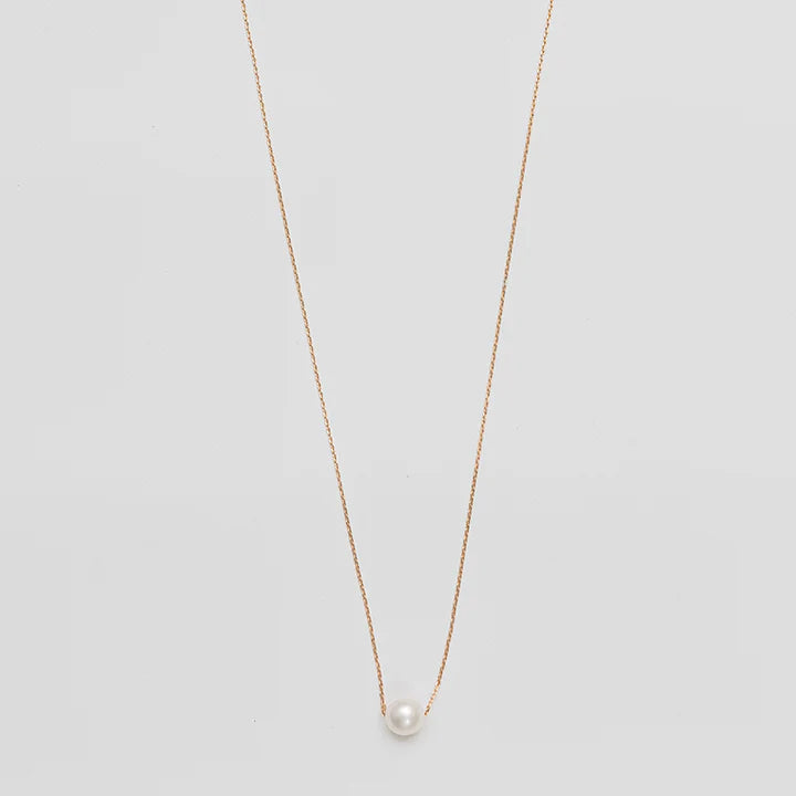 Necklace with a single pearl pendant on a light gray background