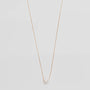 Necklace with a single pearl pendant on a light gray background