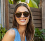 Woman wearing sunglasses with a blurred natural background